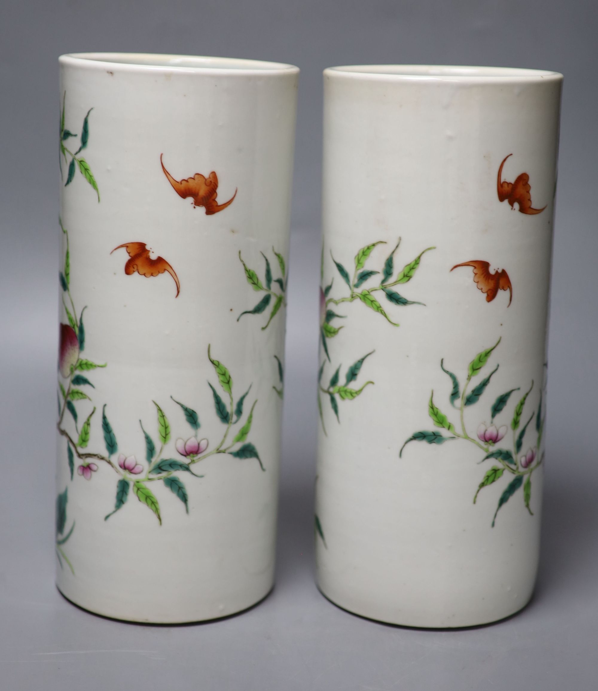 A pair of Chinese famille rose nine peach cylindrical vases, height 28cm